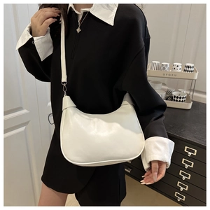 Detailed view of the white crescent bag with smooth leather finish and silver hardware buckle