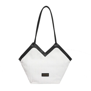 White corduroy tote bag with black leather handles and trim for professional women