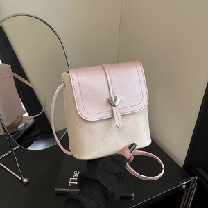 Pink and beige crossbody bag with cat pattern and heart-shaped metal buckle detail