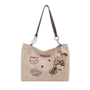 Large beige canvas tote bag with cartoon cat print and plush leopard charm detail