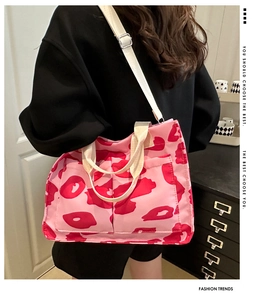 Detailed view of pink leopard print tote bag with cream straps on a fashion model