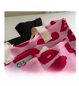 Detail of pink leopard tote bag pockets holding mobile phone and power bank