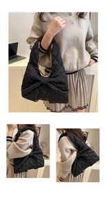 Detailansicht der schwarzen Stepptasche aus Nylon mit großer Schleife und Rautenmuster