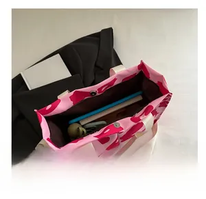 Detailed interior of a pink abstract pattern tote bag showing large storage capacity