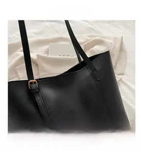 Top-down view of black leather tote bag with Fashion & Bags text and adjustable strap