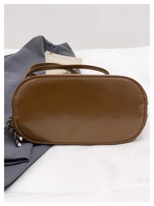 Détails du sac en cuir marron vintage avec cordon tressé et fine bandoulière réglable
