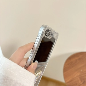 Detail of silver metallic frame and decorative accents on a folding case for Z Flip