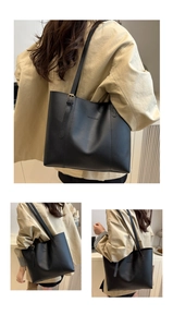 Detail of adjustable gold buckle and embossed letters on black leather tote bag