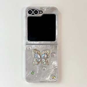 Detailed view of silver metallic fold case for Samsung Z Flip with rhinestone butterfly