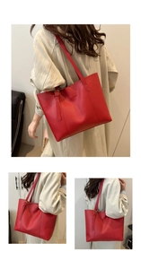 Detail of red large capacity tote bag with fashion lettering and gold metal buckle