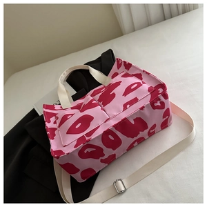 Detailed top view of pink leopard tote bag with front pockets and adjustable strap