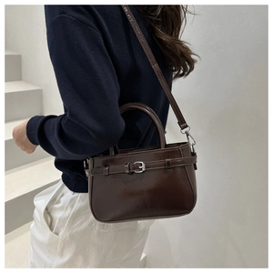 Deep brown bucket bag with shiny PU leather texture and decorative strap detail