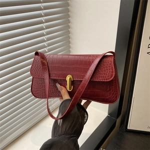 Chic burgundy faux crocodile underarm bag with gold clasp and elegant hand-held strap