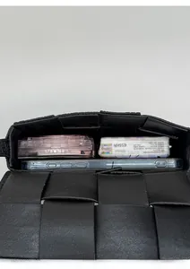 Detail view of the black woven handbag interior showing storage capacity for daily essentials