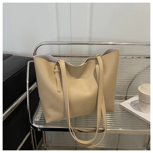 Close-up of beige tote bag made of matte faux leather with Fashion & Bags lettering