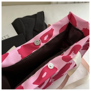 Detail of pink leopard print tote bag showing silver magnetic closure and brown lining
