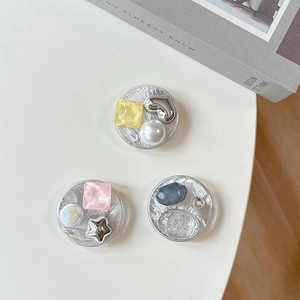 Three silver tin foil textured phone grip holders with heart and star gem decorations