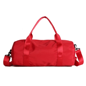 Red cylindrical sports gym bag with adjustable shoulder strap and large capacity