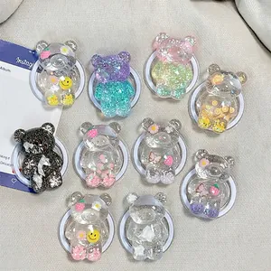 Set of 10 resin bear phone grips with glitter and floral charms on beige fabric
