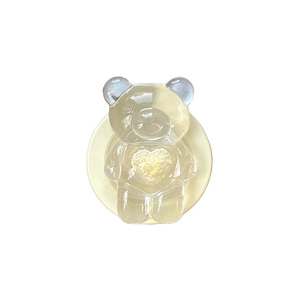 Transparent resin bear phone grip with yellow heart accessory and collapsible stand