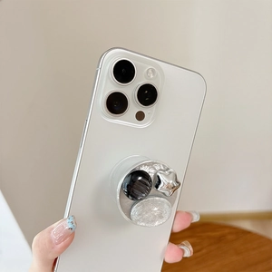Detail of silver foil texture heart and star diamond phone grip on white smartphone