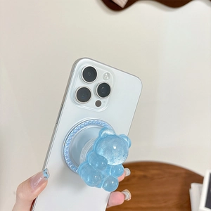 Detailed view of light blue glitter bear griptok on a smartphone held by a model