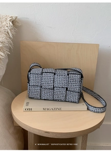 Detail of French retro woven crossbody bag with black and white letter patterns