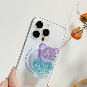 Detail of a sparkling gradient bear phone socket with purple glitter on a white smartphone