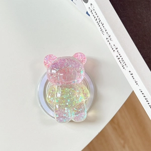 Detail of glitter-filled bear phone grip with sparkling pink and green sequins
