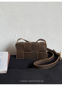 Detailed close-up of woven geometric patterns and antique bronze buckle on retro bag