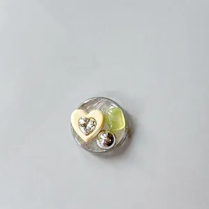 Detail of silver heart gemstone phone grip with sparkling rhinestone on textured base