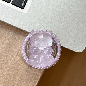 Detail of purple glitter bear phone socket with pearl border on metallic background