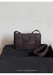 Macro detail of dark coffee retro woven leather texture on a chic shoulder bag