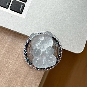 Macro view of a bear-shaped phone grip with iridescent beads and resin texture