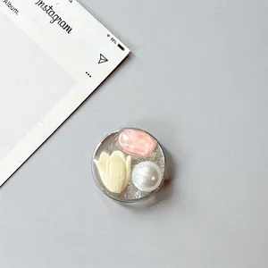 Detail of round phone socket with yellow tulip, pearl and pink sequins decoration
