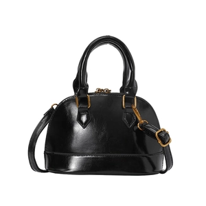 Vintage black glossy leather shell bag with gold hardware and adjustable strap