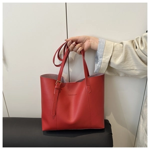 Detail of red leather tote bag with gold buckle and Fashion & Bags text logo
