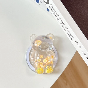 Detailed macro of bear phone grip with glitter and miniature orange slices inside resin