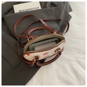 Interior view of small strawberry shell bag showing capacity for phone and wallet