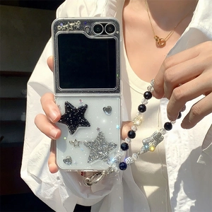 Detail of transparent Z Flip case with glitter stars, gold hearts and beaded lanyard