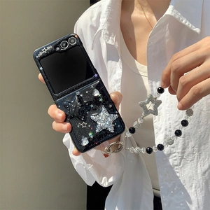 Detail of black glitter star phone case for Samsung Z Flip with beaded star hand strap