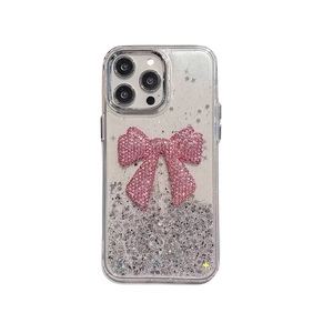 Clear iPhone case featuring a sparkling pink glitter bow and silver sequins on white background