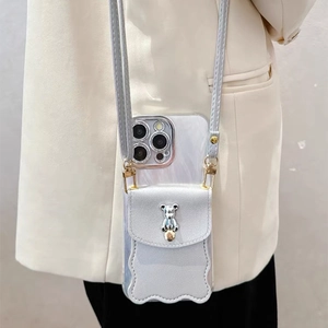 Gray leather iPhone case with bear card holder and crossbody strap on a blazer outfit