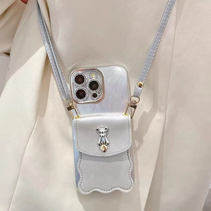 Crossbody iPhone case detail with silver bear wallet and adjustable leather shoulder strap