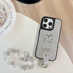 Detail of silver crinkled leather case with rhinestone butterfly and luxury beaded strap