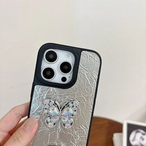 Detail of silver crinkled leather iPhone case with a sparkling rhinestone butterfly ornament