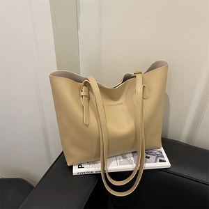 Chic beige large capacity leather tote bag with adjustable shoulder strap and fashion embossing