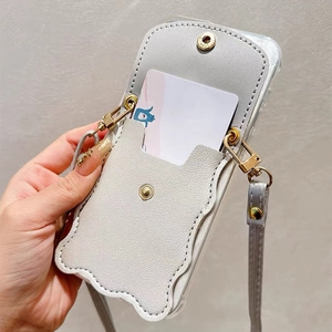 Detail of grey pebble leather phone case with wavy card slot and gold metal crossbody strap