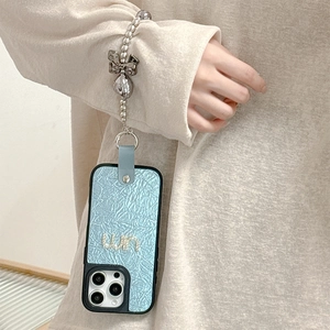 Light blue leather iPhone case with gold un logo and silver bow bead chain strap