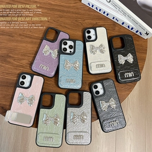 Faux leather fold-over iPhone case with metal bow, makeup mirror and pleated texture